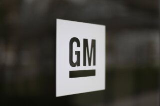 FILE - This Friday, May 16, 2014, file photo, shows the General Motors logo at the company's world headquarters in Detroit. The U.S. is making General Motors recall and repair nearly 6 million big pickup trucks and SUVs equipped with potentially dangerous Takata air bag inflators. The move announced Monday, Nov. 23, 2020, by the National Highway Traffic Safety Administration will cost the automaker an estimated $1.2 billion.   (AP Photo/Paul Sancya, File)