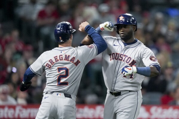 Houston Astros designated hitter Yordan Alvarez, right, celebrates after his two-run home run with Alex Bregman during the fifth inning of a baseball game against the Los Angeles Angels, Saturday, June 8, 2024, in Anaheim, Calif. Bregman also scored on the hit. (AP Photo/Ryan Sun)