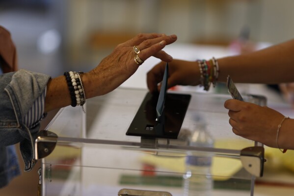 A woman casts her ballotin the 2nd spherical of the legislative elections, Sunday, July 7, 2024 in Rennes, western France. (AP Photo/Jeremias Gonzalez)