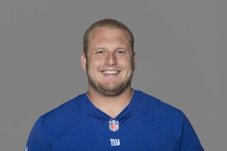 FILE - This 2012 file photo, shows Mitch Petrus of the New York Giants NFL football team. Officials say Petrus, a former Arkansas offensive lineman who later won a Super Bowl with the New York Giants, has died in Arkansas of apparent heat stroke. He was 32.  Pulaski County Coroner Gerone Hobbs says Petrus died Thursday, July 18, 2019, at a North Little Rock hospital. Hobbs says Petrus had worked outside all day at his family shop, and that his cause of death is listed as heat stroke. (AP Photo/File)