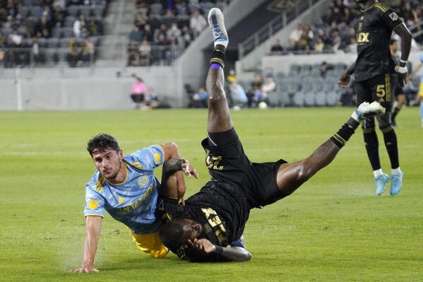 Philadelphia Union forward Julian Carranza, left, and Los Angeles FC defender Sebastien Ibeagha tangle during the first half of a Major League Soccer match Saturday, May 7, 2022, in Los Angeles. (AP Photo/Mark J. Terrill)