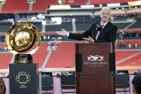FIFA President Gianni Infantino gestures toward the FIFA Club World Cup soccer trophy during a news conference at Mercedes-Benz Stadium, Monday, April 14, 2025, to discuss the upcoming 2025 Club World Cup which is to be hosted by Atlanta this summer. (Miguel Martinez/Atlanta Journal-Constitution via AP, File)