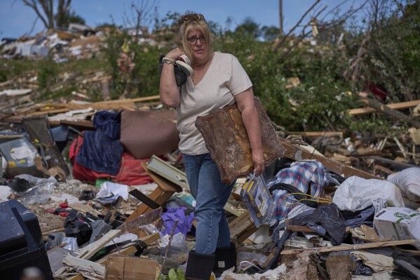 Edwina Wilson stands in what is left of her destroyed home, Sunday, May 18, 2025, in London, Ky., after a severe storm passed through the area. (AP Photo/Carolyn Kaster)