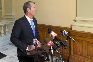 Georgia Gov. Brian Kemp speaks to reporters on Thursday, July 29, 2021, at the state capitol in Atlanta. The Republican governor says he encourages people to get vaccinated against COVID-19 but doesn't envision other measures unless hospitals get overwhelmed. (AP Photo/Jeff Amy)