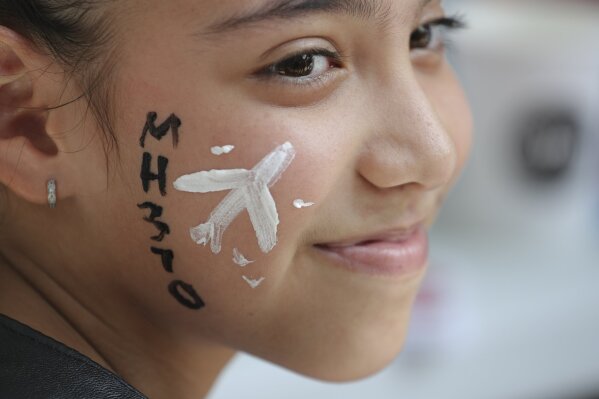 
              In this March 3, 2019, photo, a girl has her face painted with a missing plane during a Day of Remembrance for MH370 event in Kuala Lumpur, Malaysia. Five years ago, Malaysia Airlines Flight MH370, a Boeing 777, had gone missing the day before while over the South China Sea with 239 people on board. (AP Photo/Vincent Thian, File)
            