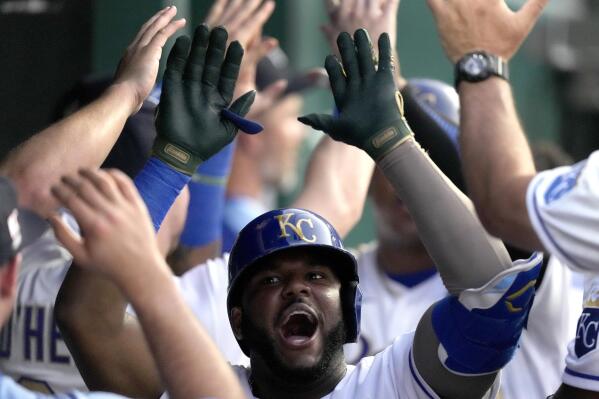 Kansas City Royals' Hanser Alberto celebrates in the dugout after hitting a two-run home run during the third inning of a baseball game against the Minnesota Twins Friday, July 2, 2021, in Kansas City, Mo. (AP Photo/Charlie Riedel)