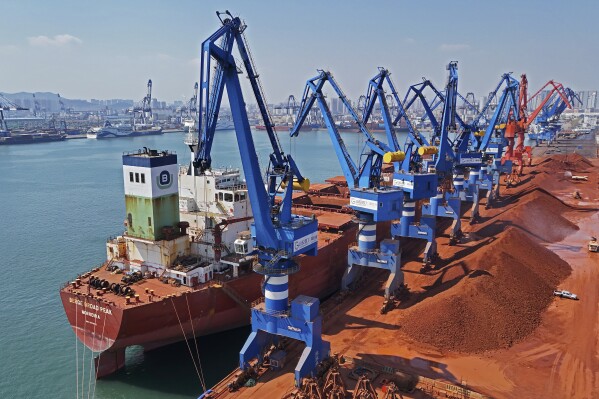 An aerial view of the iron ore imported in a port of Yantai City, in the province of Shandong in eastern China, Sunday March 30, 2025. (Chinatopix via AP) China Out