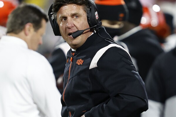 FILE - Oklahoma State head coach Mike Gundy stands on the sideline during the second half of an NCAA college football game against Oklahoma, Nov. 19, 2022, in Norman, Okla. “I think that we have the most exciting conference right now, because it wouldn't be fair for any of us to say that we actually know what's going to happen in Big 12 Conference play this year," said Gundy, the league's longest-tenured coach in his 19th season. (AP Photo/Alonzo Adams, File)