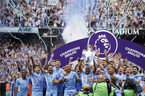 FILE - Manchester City players celebrate with trophy after winning the 2022 English Premier League title at the Etihad Stadium in Manchester, England, Sunday, May 22, 2022. (AP Photo/Dave Thompson, File)