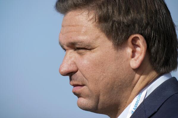 FILE - In this Saturday, May 8, 2021, file photo, Gov. Ron DeSantis, of Florida, watches the foursome matches during the Walker Cup golf tournament, in Juno Beach, Fla. DeSantis is pushing the Biden administration to approve a program he says would save tens of millions of dollars by importing drugs from Canada. (AP Photo/Brynn Anderson, File)