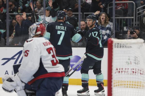 Seattle Kraken center Jaden Schwartz (17) celebrates after his goal with right wing Jordan Eberle as Washington Capitals goaltender Darcy Kuemper looks on during the second period of an NHL hockey game Thursday, Dec. 1, 2022, in Seattle. (AP Photo/Jason Redmond)