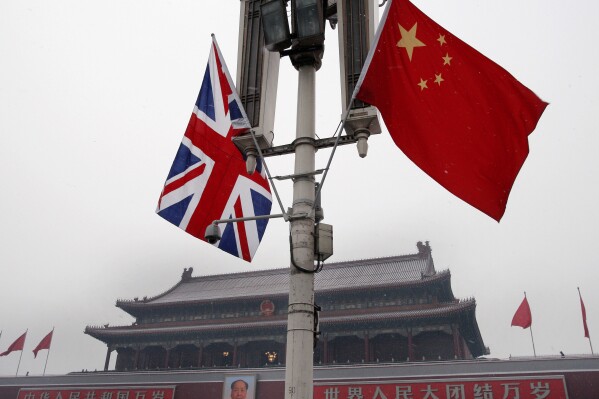 FILE - British and Chinese national flags are seen on display in front of the Tiananmen Gate in Beijing, China, Jan. 17, 2008. Beijing confirmed Friday, Jan. 26, 2024, that longtime British businessperson Ian J. Stones in China had been sentenced to five years in prison in 2022 on an espionage charge. (AP Photo/Andy Wong, File)
