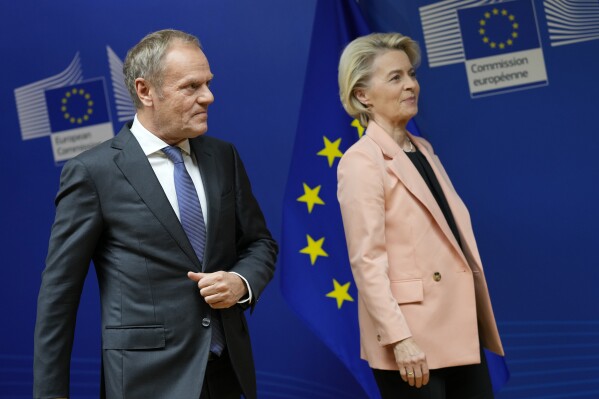 Leader of the Polish Civic Coalition Donald Tusk, left, and European Commission President Ursula von der Leyen walk off the podium after addressing a media conference at EU headquarters in Brussels, Wednesday, Oct. 25, 2023. (AP Photo/Virginia Mayo)
