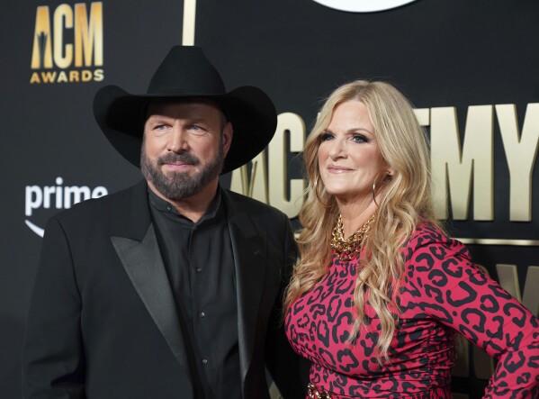 FILE - Garth Brooks, left, and Trisha Yearwood appear at the 58th annual Academy of Country Music Awards in Frisco, Texas on May 11, 2023. The couple hosted Habitat for Humanity's annual Jimmy and Rosalynn Carter Work Week Project, which began on Sunday. (AP Photo/Jeffrey McWhorter, File)