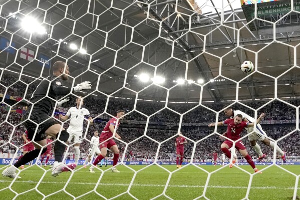 England's Jude Bellingham, right, scores the opening goal during a Group C match between Serbia and England at the Euro 2024 soccer tournament in Gelsenkirchen, Germany, Sunday, June 16, 2024. (AP Photo/Martin Meissner)