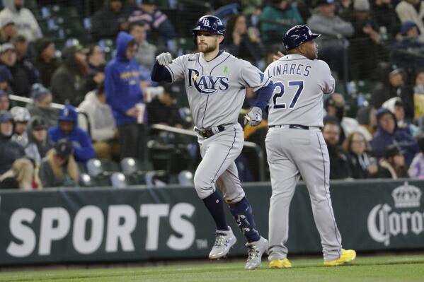 Tampa Bay Rays' Brandon Lowe celebrates with third-base coach Rodney Linares after hitting a home run during the fourth inning of the team's baseball game against the Seattle Mariners, Saturday, May 7, 2022, in Seattle. (AP Photo/Jason Redmond)