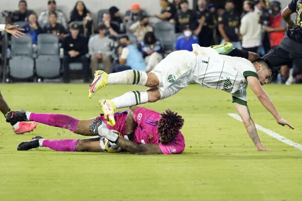 Los Angeles FC goalkeeper Jamal Blackman, top, stops a shot under Portland Timbers forward Felipe Mora during the first half of an MLS soccer match Wednesday, Sept. 29, 2021, in Los Angeles. (AP Photo/Marcio Jose Sanchez)