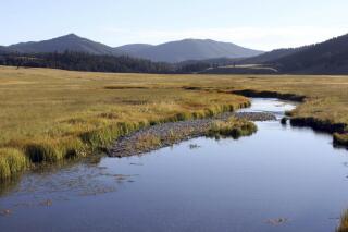 FILE - In this Sept. 3, 2010 file photo, the East Fork of the Jemez River cuts through Valles Caldera National Preserve, N.M. A Native American tribe has had its title to a portion of a national preserve in northern New Mexico recognized following a years-long court battle against the federal government. The 10th U.S. Circuit of Appeals issued a split ruling Wednesday, March 22, 2023, in the case of Jemez Pueblo and the Valles Caldera National Preserve. (AP Photo/Susan Montoya Bryan, File)
