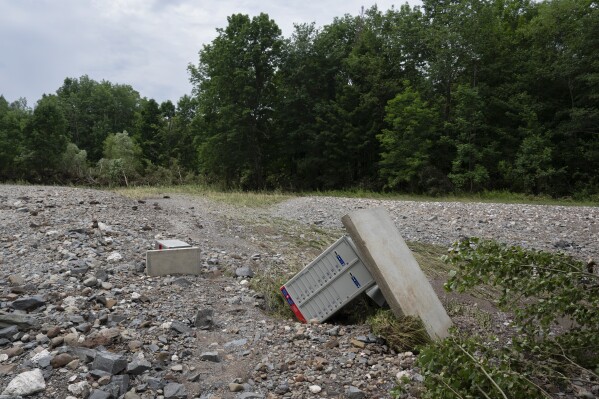 Rocks, sand, and upended Canada Post boxes are seen in what used to be a hay field near McKay Section, Nova Scotia on Sunday, July 23, 2023. A long procession of intense thunderstorms dumped record amounts of rain across a wide swath of Nova Scotia, causing flash flooding, road washouts and power outages. (Darren Calabrese/The Canadian Press via AP)