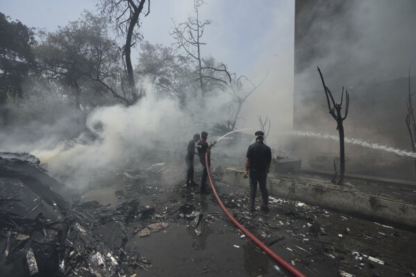 Firefighters work at the site of an airplane that crashed in India's northwestern city of Ahmedabad in Gujarat state, Thursday, June 12, 2025. (AP Photo/Ajit Solanki)