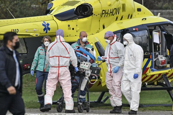 A COVID-19 patient from the Netherlands arrives for treatment by helicopter to the University hospital in Muenster, Germany, Friday, Oct. 23, 2020. The transfer is intended to reduce the coronavirus pressure on the intensive care units in the Netherlands. (AP Photo/Martin Meissner)