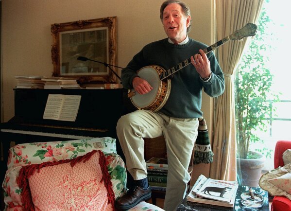 FILE - Actor George Segal plays the banjo at his home in Los Angeles on Feb. 21, 1997. Segal, the banjo player turned actor who was nominated for an Oscar for 1966's “Who’s Afraid of Virginia Woolf?,” and starred in the ABC sitcom “The Goldbergs,” died Tuesday, his wife said. He was 87.  (AP Photo /Damian Dovarganes, File)
