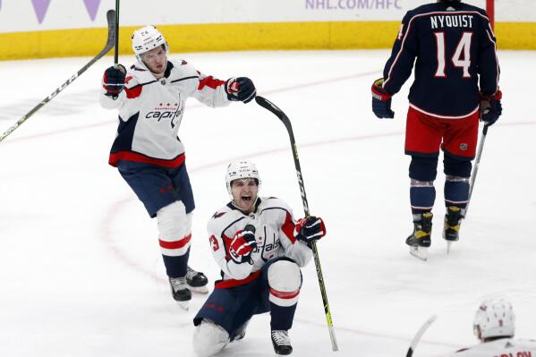 Washington Capitals forward Conor Sheary (73) celebrates his goal against the Columbus Blue Jackets with forward Connor McMichael (24) and defenseman Dmitry Orlov (9) during the third period of an NHL hockey game in Columbus, Ohio, Friday, Nov. 12, 2021. The Capitals won 4-3. (AP Photo/Paul Vernon)