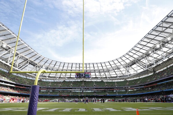 FILE - Players warm up on the field before an NCAA college football game between Northwestern and Nebraska, Saturday, Aug. 27, 2022, at Aviva Stadium in Dublin, Ireland. Iowa State and Kansas State will play their 2025 season opener in Ireland at the fourth Aer Lingus College Football Classic. The Cyclones and Wildcats will meet Aug. 23, 2025, at Aviva Stadium in Dublin. (AP Photo/Peter Morrison, File)