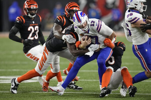 Buffalo Bills quarterback Josh Allen (17) is brought down by a host of Cincinnati Bengals defenders during the second half of an NFL football game, Sunday, Nov. 5, 2023, in Cincinnati. (AP Photo/Darron Cummings)