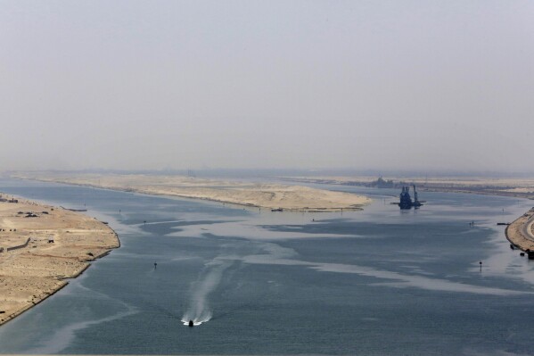 FILE - An army zodiac secures the entrance of the new section of the Suez Canal in Ismailia, Egypt, on Aug. 6, 2015. China, the world’s biggest exporter, says it is deeply concerned about tensions in the Red Sea that have upended global trade by forcing many shippers to avoid the Suez Canal. (AP Photo/Amr Nabil, File)