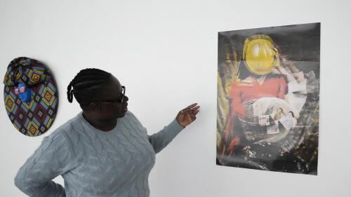 Fadzai Muchemwa, National Art Gallery curator, looks at Nothando Chiwanga's art piece, "Immortal", in Harare, Friday, April, 14, 2023. Chiwanga's "Immortal" is one of 21 works by female artists that have been on show at the southern African country's national gallery since International Women's Day on March 8. The exhibition is titled "We Should All Be Human" and is a homage to women's ambitions and their victories, Muchemwa said. (AP Photo/Tsvangirayi Mukwazhi)