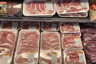 Shown are pork products at a grocery store in Roslyn, Pa., Tuesday, June 15, 2021.  The Labor Department reported Thursday Oct. 14,  that the monthly increase in its producer price index, which measures inflationary pressures before they reach consumers, was 0.5% for September compared to a 0.7% gain in August. (AP Photo/Matt Rourke)