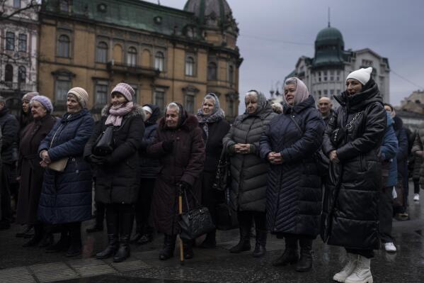 People pray for the end of the war in central Lviv, on Friday, Feb. 24, 2023, during a year anniversary of the Russia's invasion to Ukraine.(AP Photo/Petros Giannakouris)