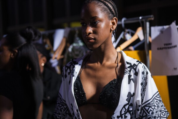 A model dresses up backstage for Niger's designer Alia Bare's show during Johannesburg Fashion Week 2023 in Johannesburg, South Africa, Thursday, Nov. 9, 2023. (AP Photo/Jerome Delay)