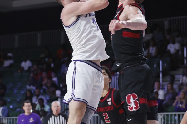 CORRECTS TO NORTHERN IOWA'S NOT NORTHERN'S - In a photo provided by Bahamas Visual Services, Stanford's James Keefe, right, blocks Northern Iowa's Cole Henry, left, who shoots during the second half of an NCAA college basketball game in the Battle 4 Atlantis at Paradise Island, Bahamas, Friday, Nov. 24, 2023. (Tim Aylen/Bahamas Visual Services via AP)