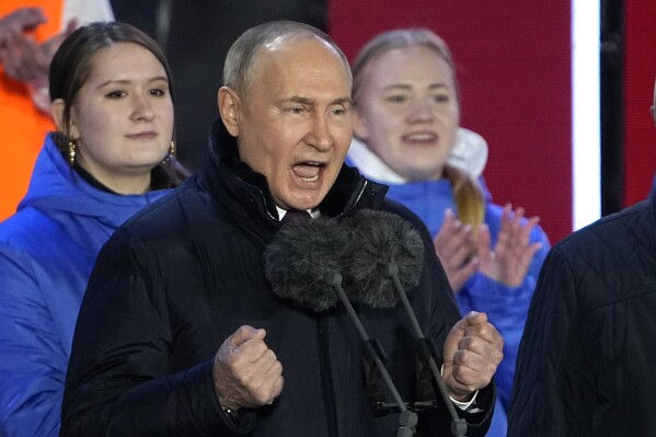 Russian President Vladimir Putin speaks at a concert marking his victory in a presidential election and the 10-year anniversary of Crimea's annexation by Russia on Red Square in Moscow, Russia, Monday, March 18, 2024. President Vladimir Putin seized Crimea from Ukraine a decade ago, a move that sent his popularity soaring but was widely denounced as illegal. (AP Photo/Alexander Zemlianichenko)