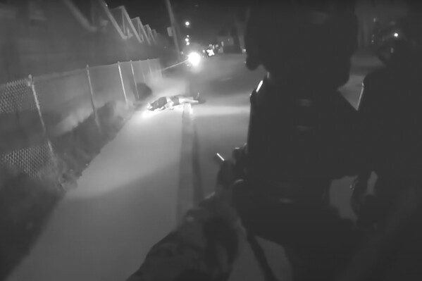 This image made from body camera footage provided by the the Connecticut Office of Inspector General shows Vaughn Malloy lying on the ground after police shot him as he ran from the rear of a home in the Pawcatuck section of Stonington, Conn., near the Rhode Island state line, Thursday, Dec. 21, 2023. According to a preliminary report released Wednesday, Dec. 27, by the state's Office of Inspector General, Malloy, who was fatally shot by police, had a pistol and fired at a police dog as he attempted to flee from the state troopers and other officers serving a warrant for a 2022 shooting. (Connecticut Office of Inspector General via AP)