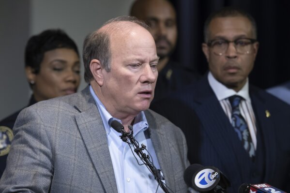FILE - In this Nov. 21, 2019 file photo, Detroit Mayor Mike Duggan speaks to the media at Detroit Public Safety Headquarters.  Duggan on Tuesday, April 14, 2020, announced some layoffs, pay cuts for other employees and and a reduction in some services. He warned that Detroit could be subject to a return to state oversight if action isn't taken quickly. (David Guralnick/Detroit News via AP File)/