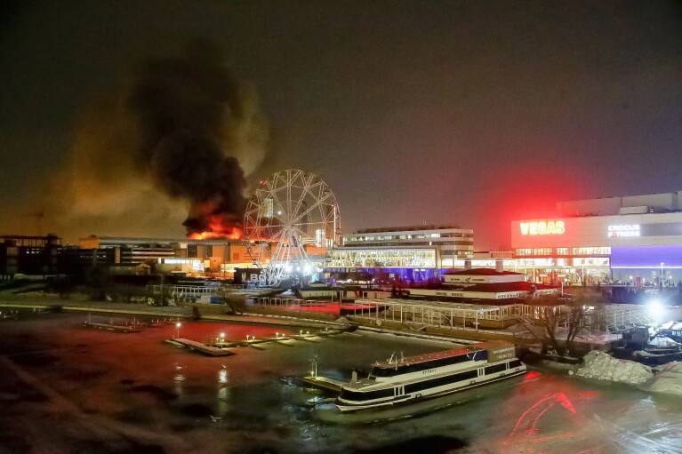 A massive blaze is seen over the Crocus City Hall on the western edge of Moscow, Russia, Friday, March 22, 2024. Several gunmen have burst into a big concert hall in Moscow and fired automatic weapons at the crowd, injuring an unspecified number of people and setting a massive blaze in an attack days after President Vladimir Putin cemented his grip on the country in a highly orchestrated electoral landlside. (Sergei Vedyashkin/Moscow News Agency via AP)