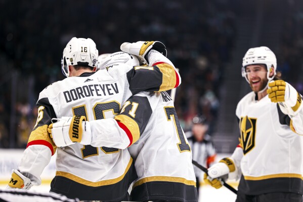 Vegas Golden Knights left wing Pavel Dorofeyev, left, celebrates after scoring a goal with center William Karlsson during the second period in an NHL hockey game against the Seattle Kraken Tuesday, March 12, 2024, in Seattle. (AP Photo/Maddy Grassy)