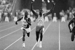 FILE - U.S. athlete Carl Lewis raises his arms in victory as he wins the 100-meter final ahead of third-place Emmit King, left, at the U.S. Olympic track and field trials at the Coliseum in Los Angeles, June 18, 1984. A former University of Alabama track star and Olympian was killed in a shootout with another man, authorities say. The Jefferson County Coroner’s Office on Monday, Nov. 29, 2021, identified Emmit King and Willie Albert Wells as the two men who died after exchanging gunfire in Bessemer on Sunday, AL.com reported. King, 62, was a sprinter and a member of the U.S. relay team for the Summer Olympics in 1984 and 1988, but he didn’t compete. (AP Photo/Lennox McLendon, File)