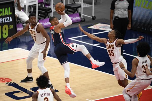 Washington Wizards guard Russell Westbrook (4) shoots against Cleveland Cavaliers forward Isaac Okoro (35), forward Mfiondu Kabengele (27), center Jarrett Allen (31) and guard Collin Sexton (2) during the second half of an NBA basketball game Friday, May 14, 2021, in Washington. (AP Photo/Nick Wass)