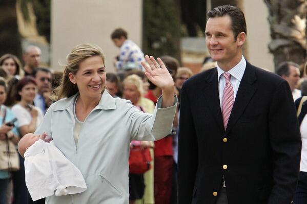 FILE - Spain's Duke of Palma Inaki Urdangarin and Princess Cristina de Borbon, left, show their daughter Irene in Barcelona, Spain, on June 8, 2005. The sister of Spain’s King Felipe VI, Cristina de Borbón, and her husband, Inaki Urdangarin, are announcing the end of their marriage after nearly 25 years together. The announcement on Monday came a week after a gossip magazine in Spain published photos of Urdangarin taking a stroll in a southern French coastal town while holding hands with a work colleague. (AP Photo/Manu Fernandez)