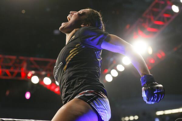 Julianna Pena reacts after defeating Amanda Nunes by submission in a women's bantamweight mixed martial arts title bout at UFC 269, Saturday, Dec. 11, 2021, in Las Vegas. (AP Photo/Chase Stevens)