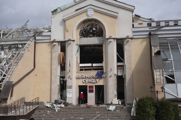 A man walks inside a building destroyed by a Russian missile strike on Sumy, Ukraine, Sunday April 13, 2025. (AP Photo/Volodymyr Hordiienko)
