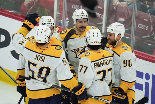 Nashville Predators left wing Filip Forsberg, center, celebrates his third goal of the game during the third period of an NHL hockey game against the Chicago Blackhawks, Friday, April 12, 2024, in Chicago. (AP Photo/Erin Hooley)