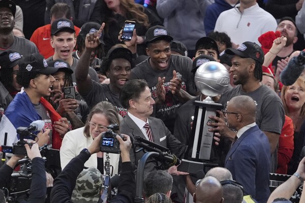 St. John's head coach Rick Pitino admires the tournment trophy after an NCAA college basketball game against Creighton in the championship of the Big East Conference tournament Saturday, March 15, 2025, in New York. (AP Photo/Frank Franklin II)