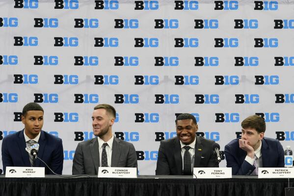 Iowa's Kris Murray, left, Connor McCaffery, center left, Tony Perkins, center right, and Patrick McCaffery, right, speak to the media during Big Ten NCAA college basketball Media Days Tuesday, Oct. 11, 2022, in Minneapolis. (AP Photo/Abbie Parr)