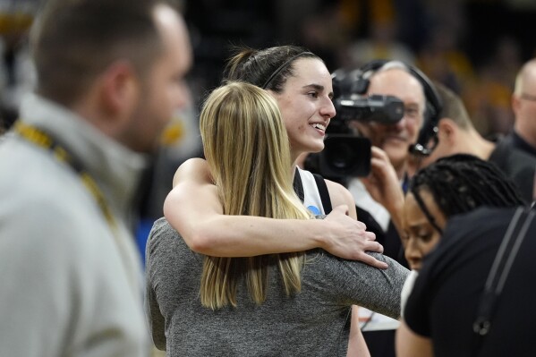 Iowa guard Caitlin Clark celebrates with teammates after a second-round college basketball game against West Virginia in the NCAA Tournament, Monday, March 25, 2024, in Iowa City, Iowa. Iowa won 64-54. (AP Photo/Charlie Neibergall)