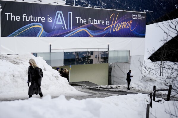 An advertising banner with a slogan about AI is fixed at a building at the Davos Promenade, alongside the World Economic Forum in Davos, Switzerland, Jan. 18, 2024.  (AP Photo/Markus Schreiber, File)